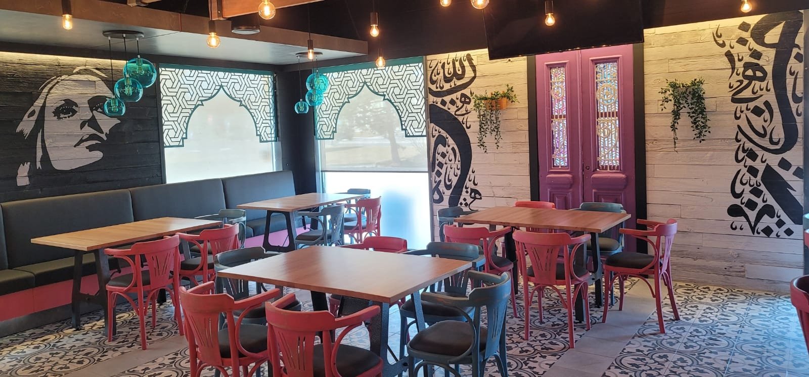 Dining room at Moods with the Fairuz mural and Arabic calligraphy